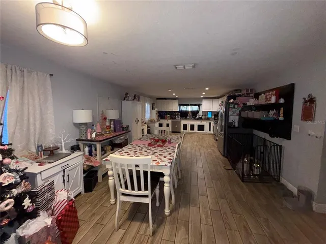 a view of a dining room with furniture a rug and wooden floor
