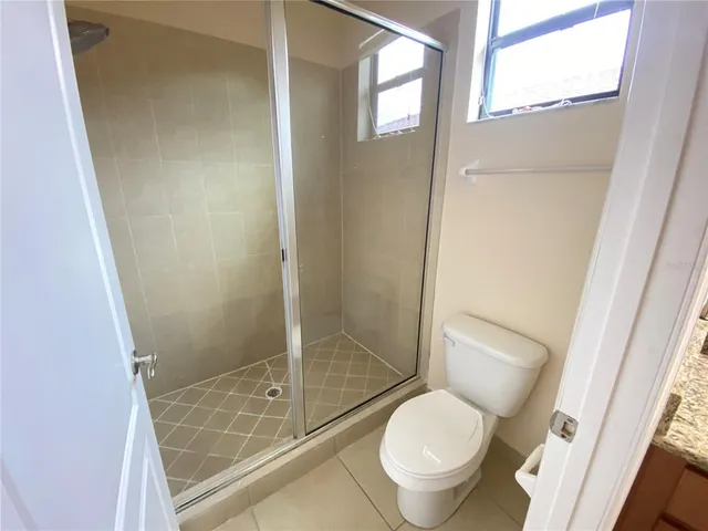 a white toilet sitting next to a tub