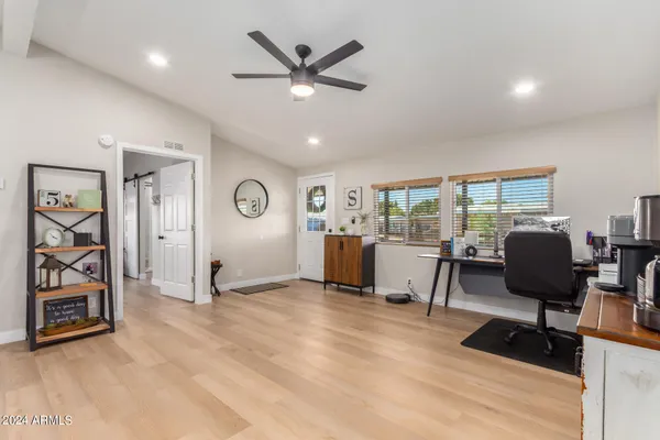 a view of a livingroom with workspace and a window