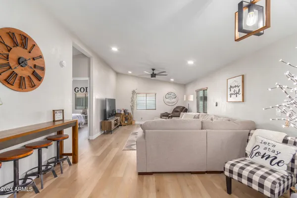 a living room with furniture and a wooden floor