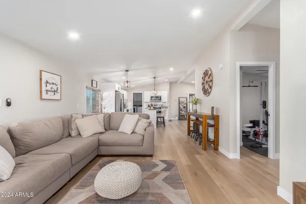 a living room with furniture and a wooden floor