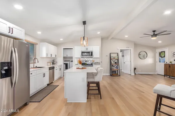 a kitchen with white cabinets and stainless steel appliances
