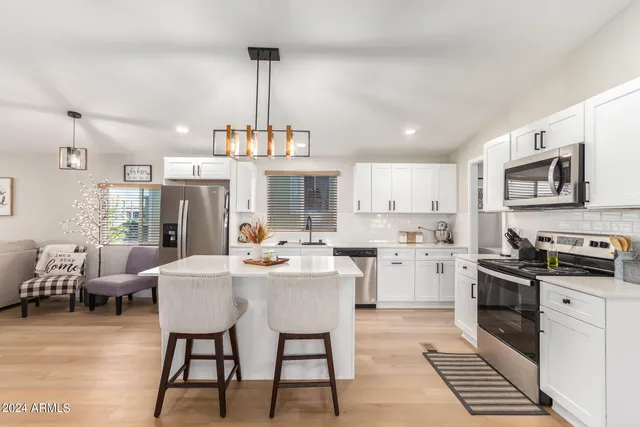a kitchen with sink cabinets and dining table