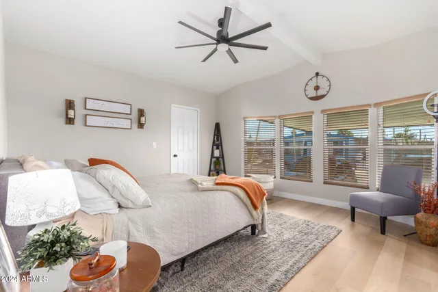 a bedroom with furniture and a large window