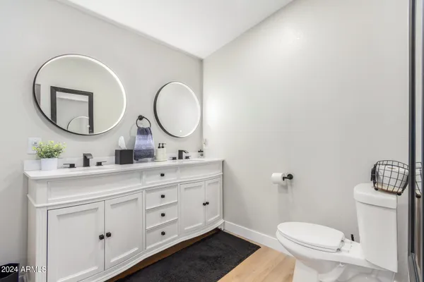 a bathroom with a toilet a mirror and a sink