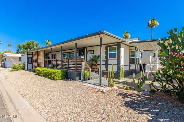 a view of a house with wooden fence