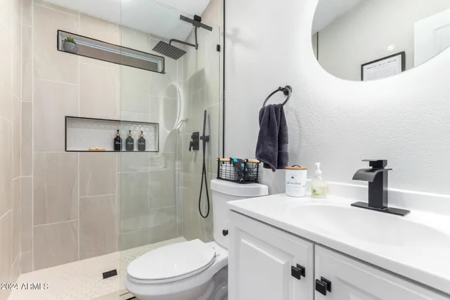 a bathroom with a sink toilet and shower