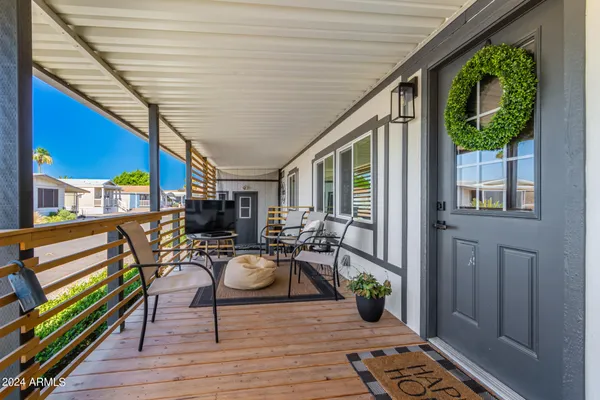 a view of a patio with chairs and potted plants