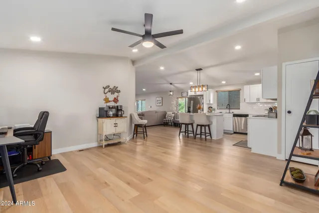 a living room with furniture and kitchen view