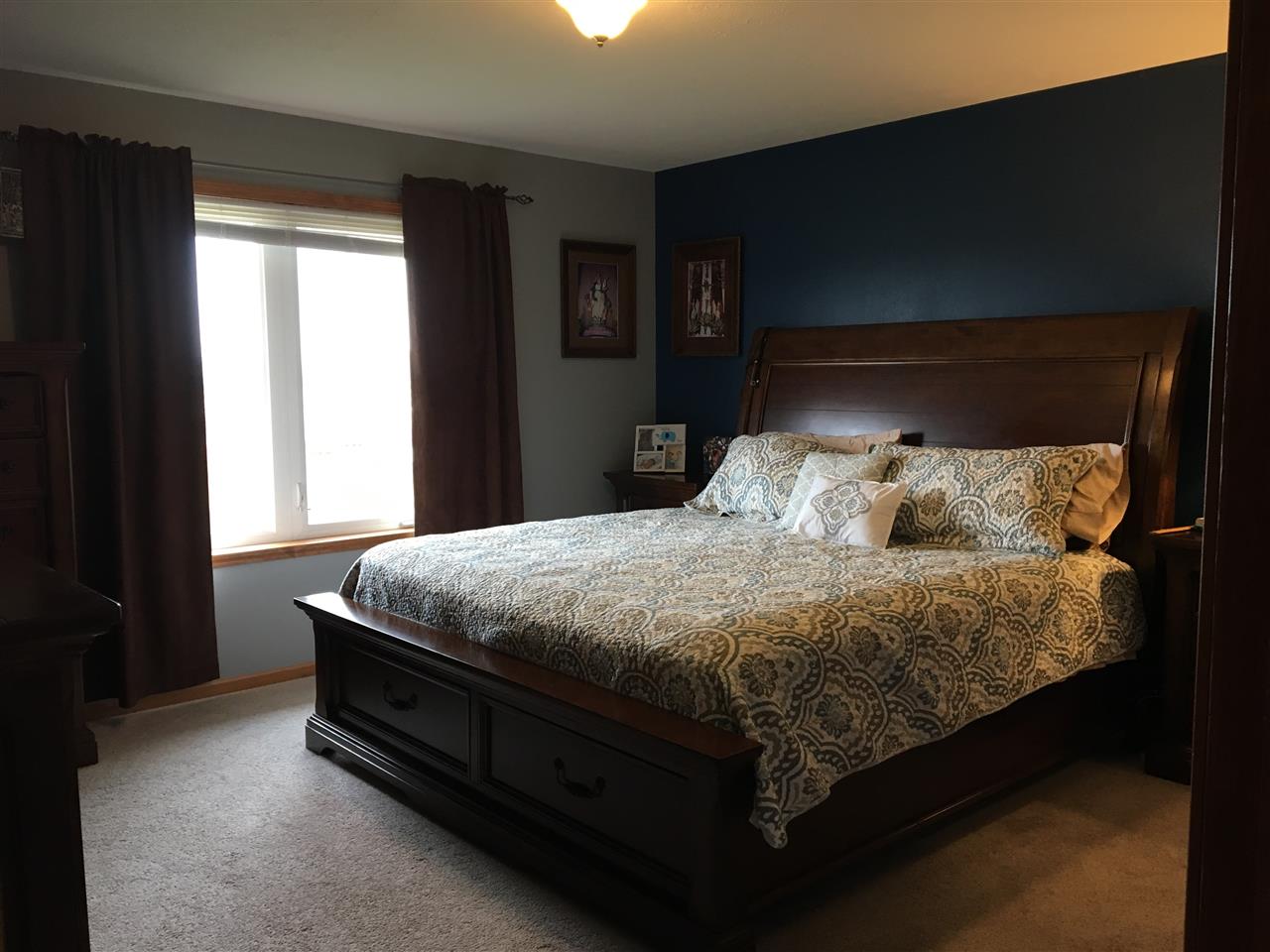 503 South Regulators Street Rochelle, IL 61068 - Photo 9 of 14 a bed sitting in a bedroom next to a window