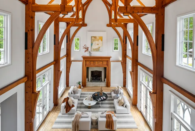 a view of hall way with furniture and a fireplace