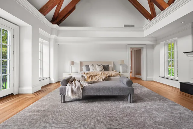 a spacious bedroom with a bed and a large window