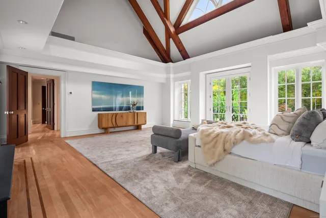 a living room with a bed furniture and a large window