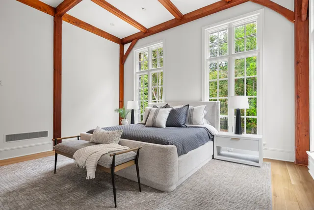 a spacious bedroom with a bed and a window