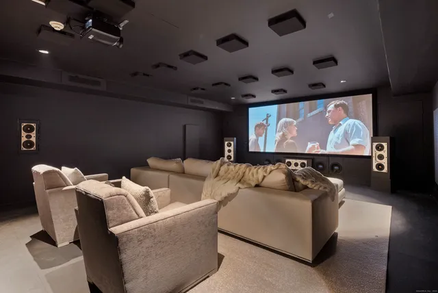 a living room with furniture and a projector screen
