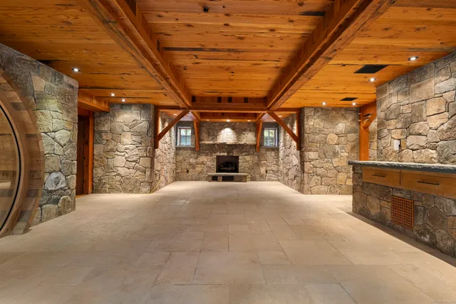 a front view of a house with a garden and trees