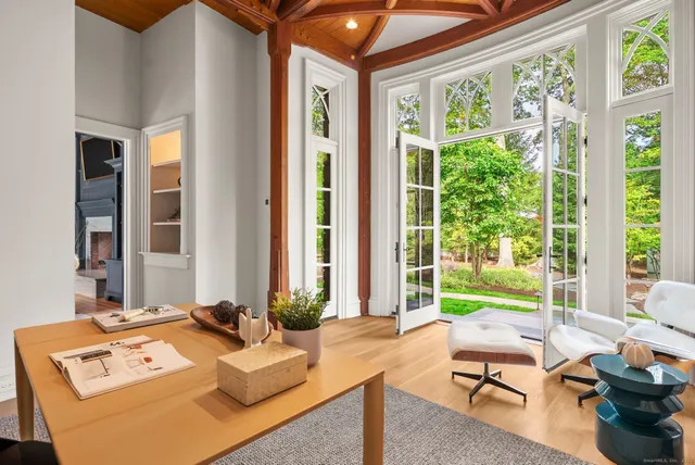 a living room with furniture and large windows