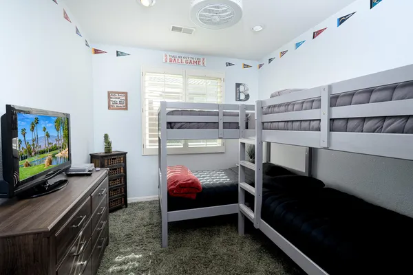 a bedroom with furniture and a flat screen tv