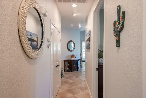 a view of a hallway to a livingroom and furniture