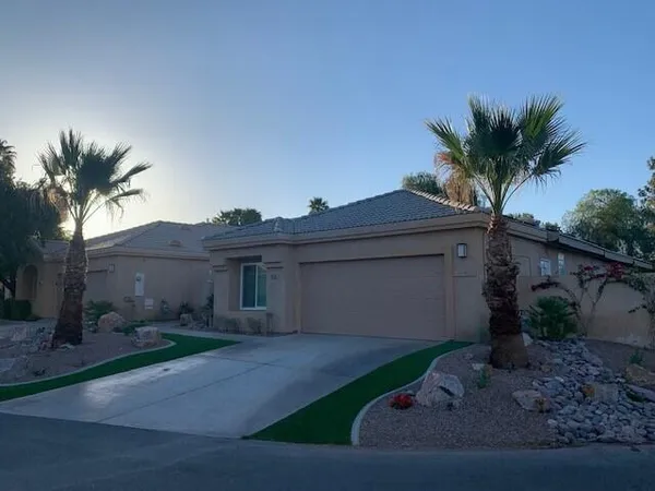 a view of a house with a yard and a garage