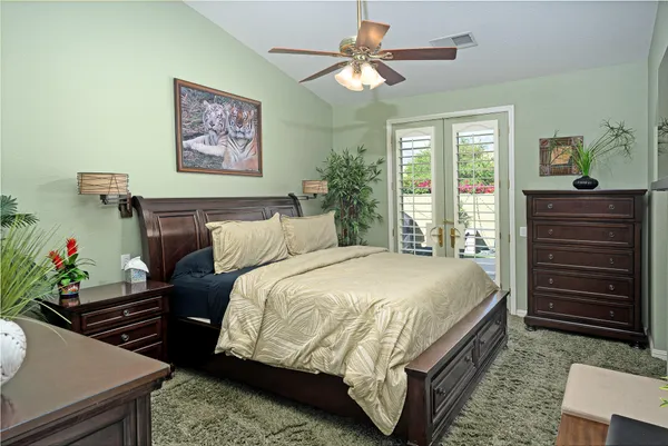 a bedroom with a bed and a chandelier
