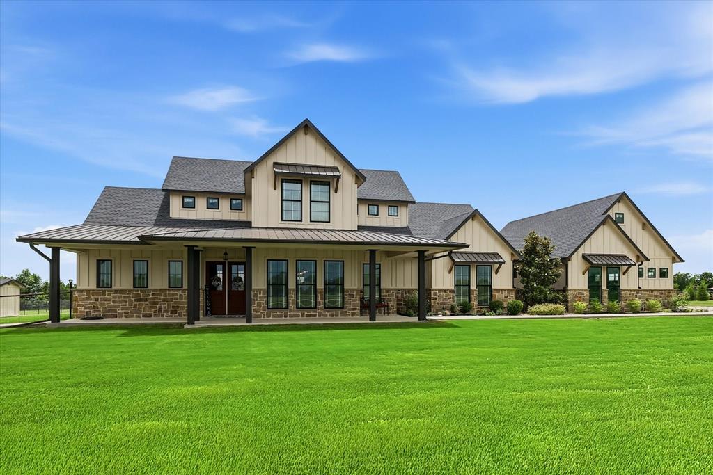 6020 Honeysuckle Road Midlothian, TX 76065 - Photo 39 of 39 Expansive two-story residence featuring a covered front porch with dark pillars, light siding, and stone accents