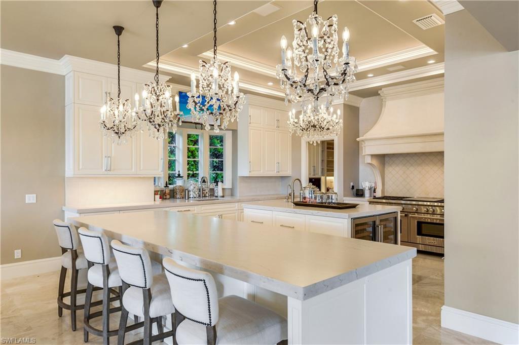 2300 Kingfish Road Naples, FL 34102 - Photo 14 of 36 a kitchen with a table and chairs in it