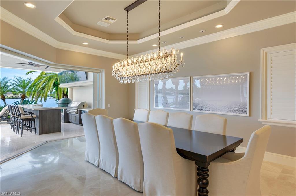2300 Kingfish Road Naples, FL 34102 - Photo 15 of 36 a view of a dining room with furniture and chandelier