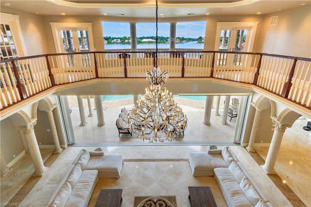 2300 Kingfish Road Naples, FL 34102 - Photo 25 of 36 a view of a living room and balcony with furniture