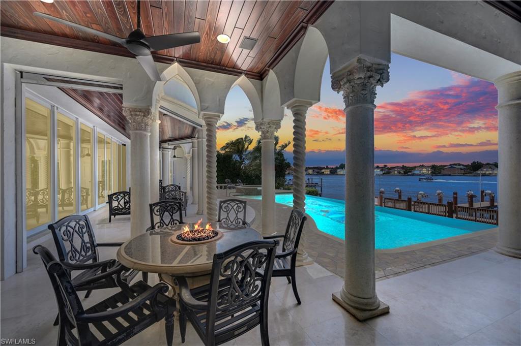 2300 Kingfish Road Naples, FL 34102 - Photo 3 of 36 a view of a patio with a table chairs and a table