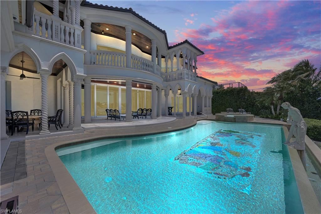 2300 Kingfish Road Naples, FL 34102 - Photo 31 of 36 a view of a swimming pool with an outdoor seating