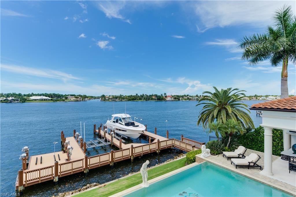 2300 Kingfish Road Naples, FL 34102 - Photo 33 of 36 a view of a lake with couches and city view