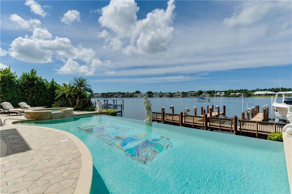 2300 Kingfish Road Naples, FL 34102 - Photo 34 of 36 a view of a lake with houses in the back