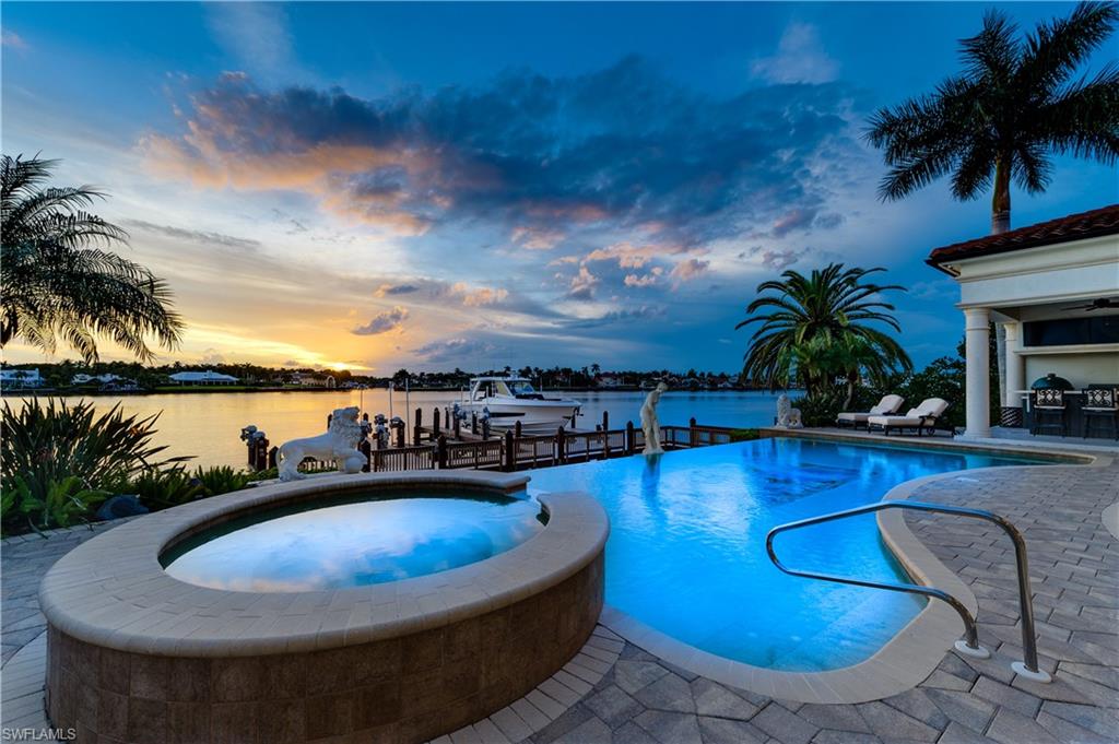 2300 Kingfish Road Naples, FL 34102 - Photo 7 of 36 a view of a swimming pool with chair and table