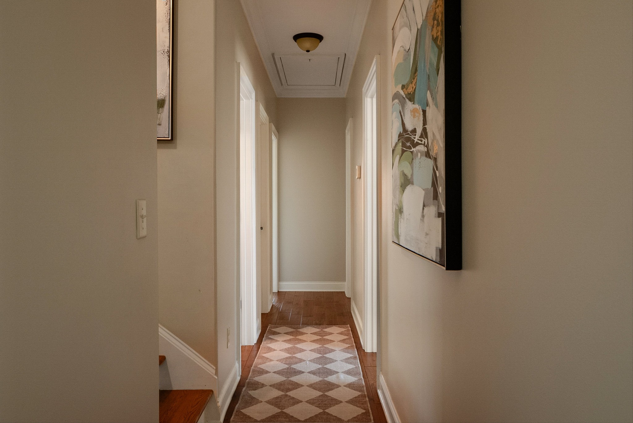 1058 Alice Springs Circle Spring Hill, TN 37174 - Photo 34 of 54 a view of a hallway with wooden floor and staircase