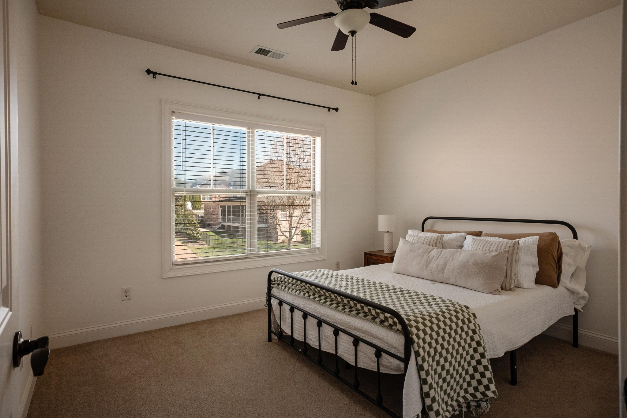 1058 Alice Springs Circle Spring Hill, TN 37174 - Photo 39 of 54 a bedroom with a bed a chandelier and a window