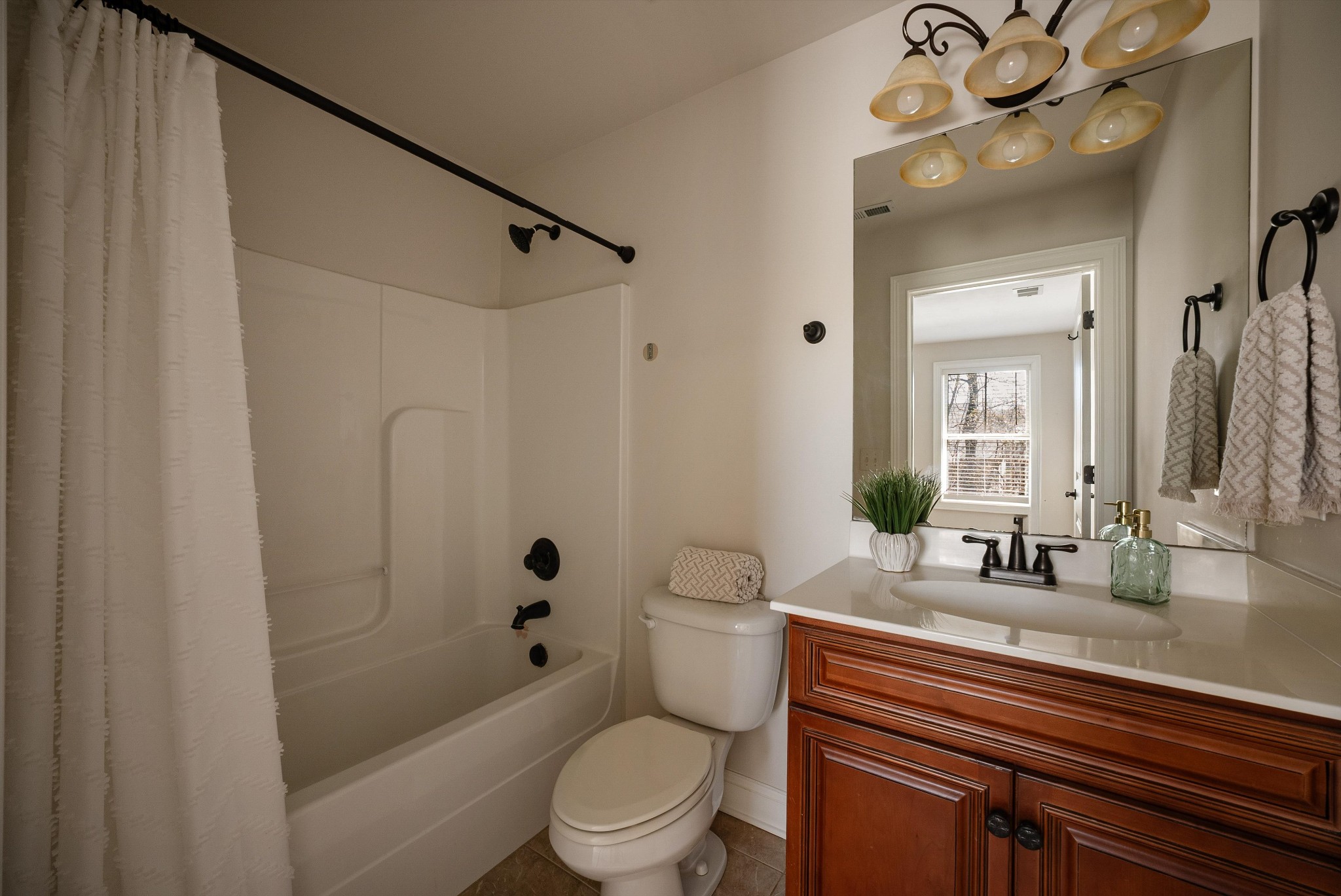 1058 Alice Springs Circle Spring Hill, TN 37174 - Photo 42 of 54 a bathroom with a sink a toilet a mirror and shower
