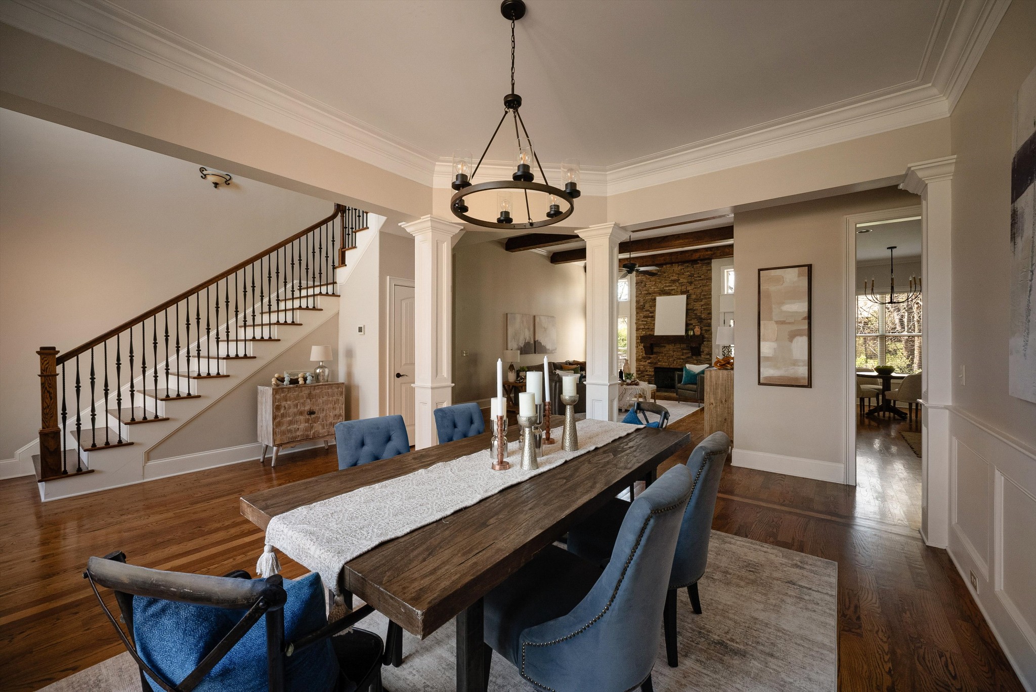 1058 Alice Springs Circle Spring Hill, TN 37174 - Photo 7 of 54 a dining room with wooden floor a chandelier a wooden table and chairs