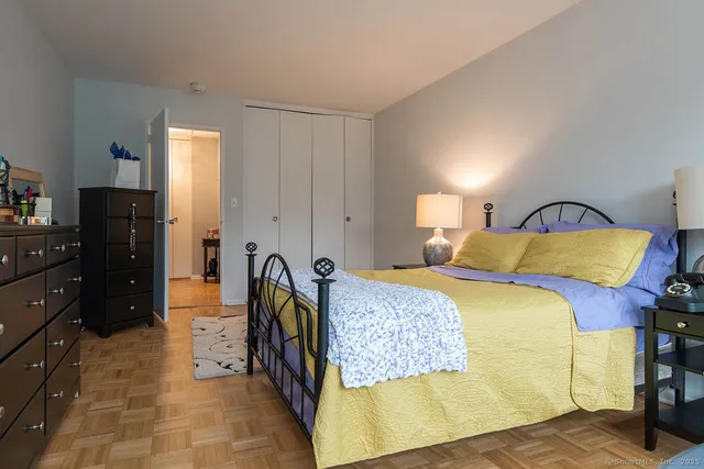 a bedroom with a bed and dresser