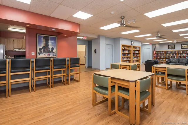 a dinning room with furniture a wooden floor and chandelier