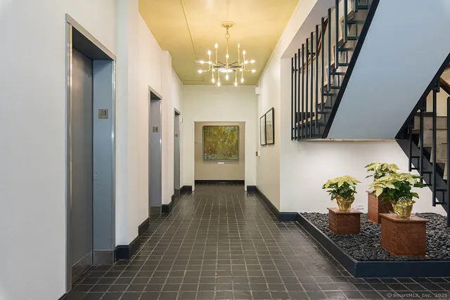 a lobby with furniture and a chandelier