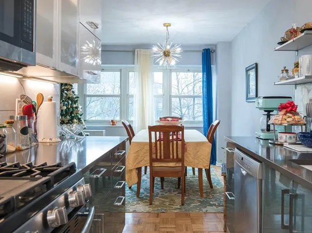a view of a dining room with furniture and chandelier