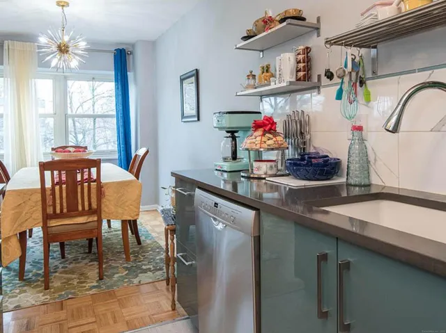 a dining room with furniture a rug and a chandelier