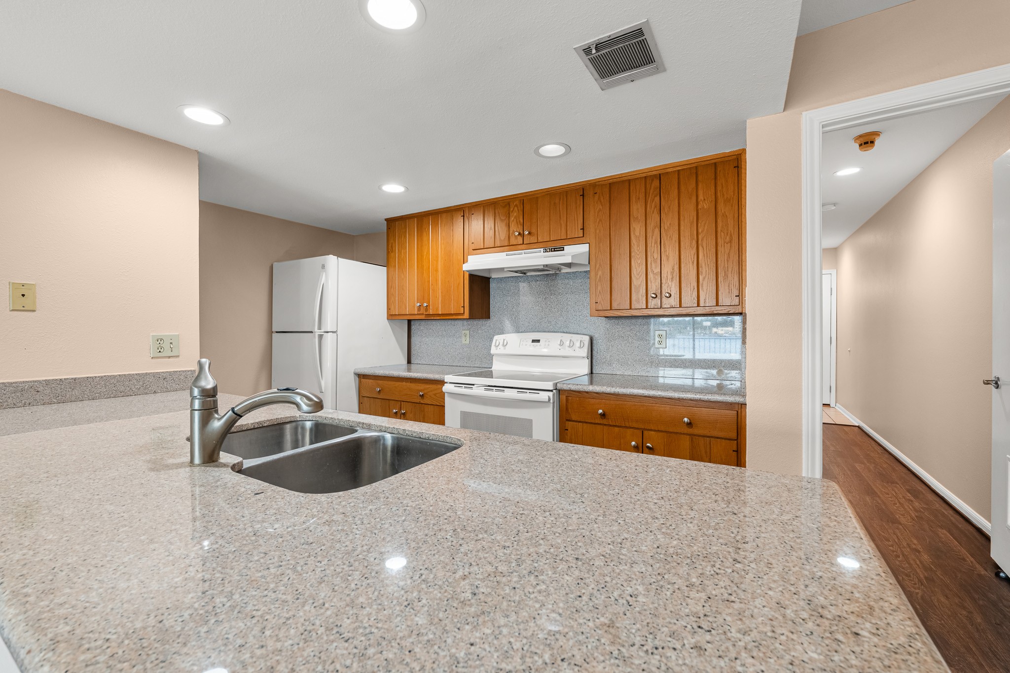 15575 Marina Drive, Unit 215C Montgomery, TX 77356 - Photo 13 of 31 a kitchen with granite countertop a sink and cabinets