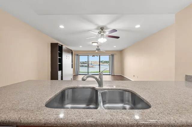 a kitchen with granite countertop a sink and a window