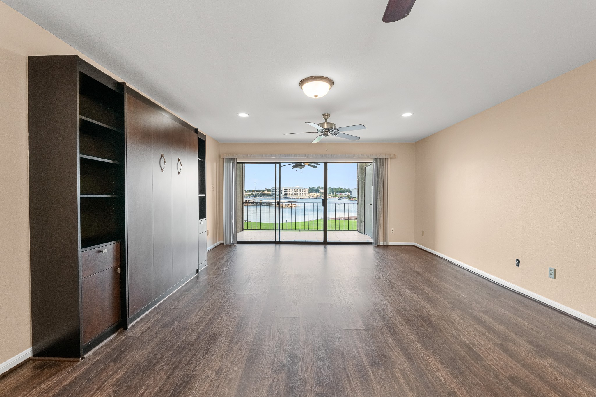 15575 Marina Drive, Unit 215C Montgomery, TX 77356 - Photo 16 of 31 a view of an empty room with wooden floor and a window