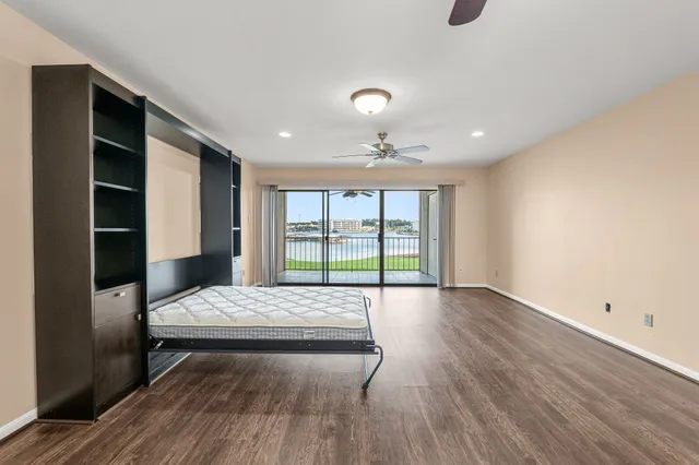 a living room with a bed furniture and a window