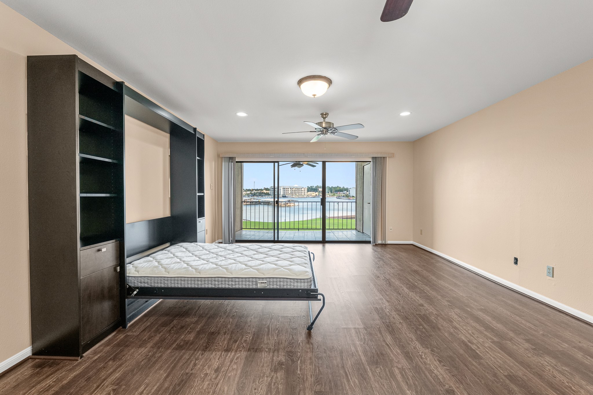 15575 Marina Drive, Unit 215C Montgomery, TX 77356 - Photo 17 of 31 a living room with a bed furniture and a window