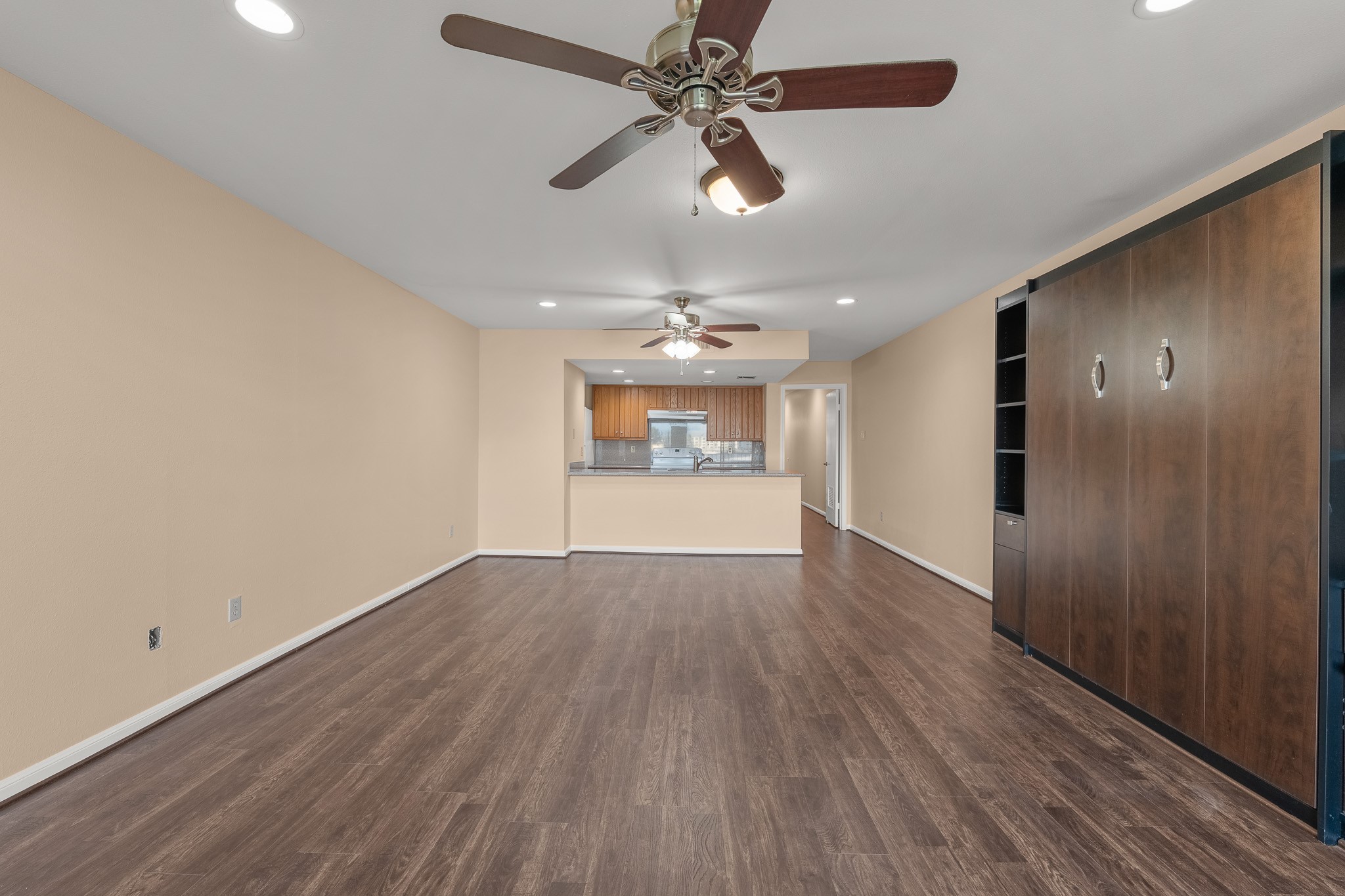 15575 Marina Drive, Unit 215C Montgomery, TX 77356 - Photo 30 of 31 an empty room with wooden floor chandelier fan and windows