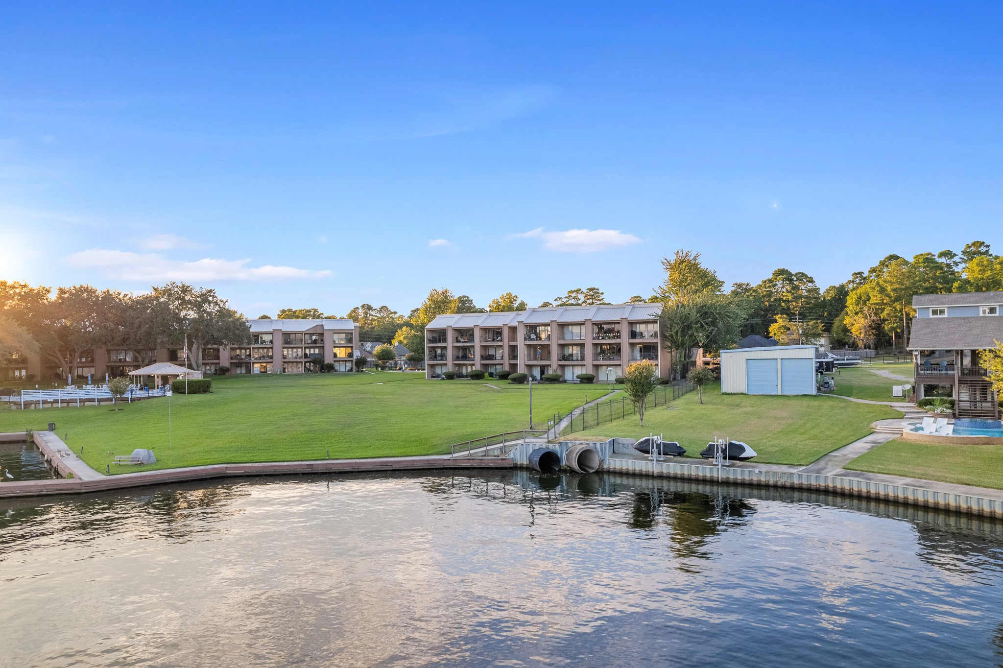 15575 Marina Drive, Unit 215C Montgomery, TX 77356 - Photo 23 of 31 a view of a patio with table and chairs under an umbrella